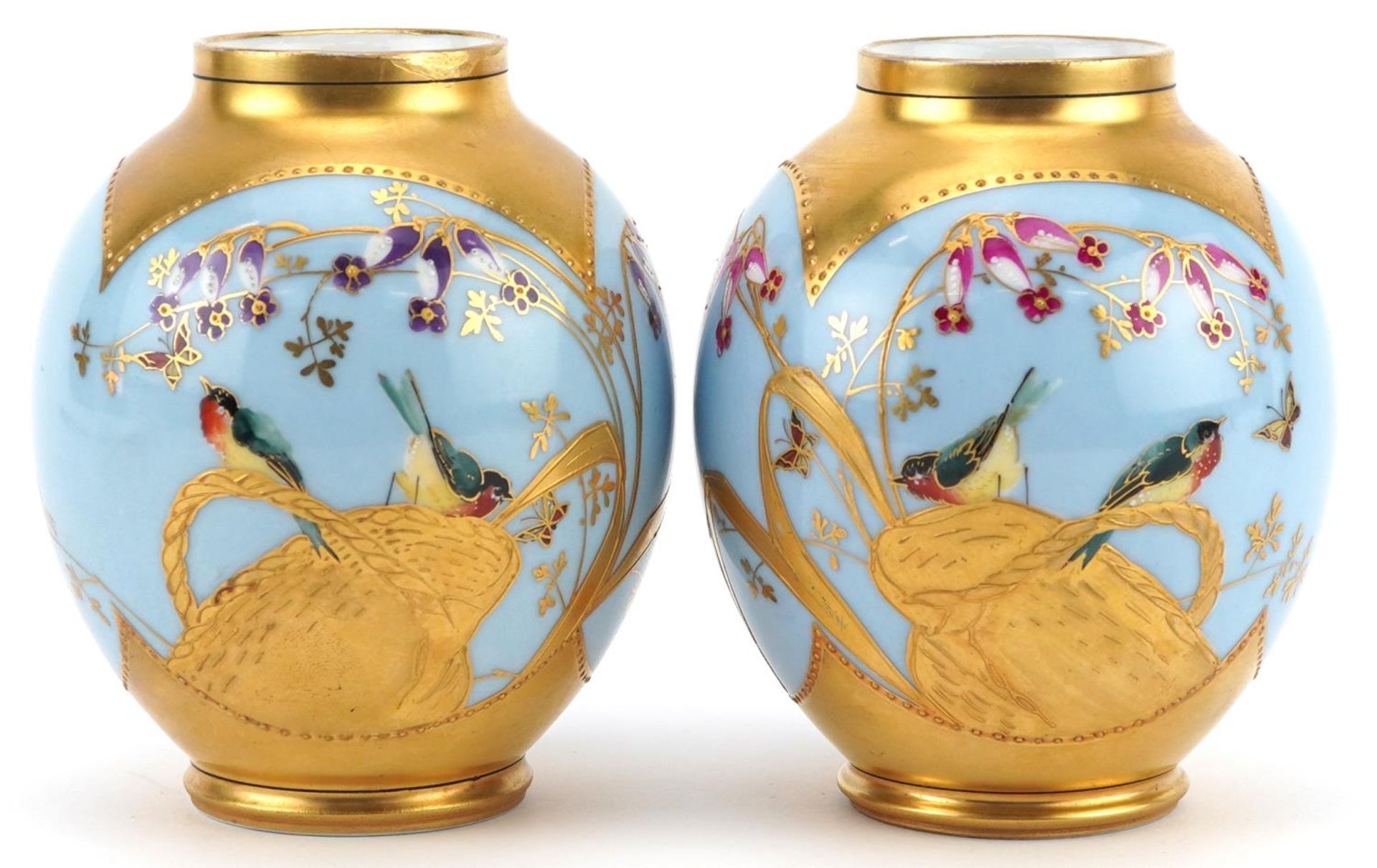 Limoges, pair of French blue ground porcelain vases hand painted and gilded with stylised birds