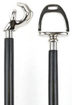 Two ebonised walking sticks with chromed handles, one in the form of a hand holding a crystal