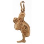 9ct gold charm in the form of a stork carrying a newborn baby, 2.7cm high, 1.1g