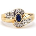 Modernist 14ct gold sapphire and clear stone crossover ring, size O, 3.8g