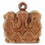 Unmarked gold charm in the form of the three wise monkeys, 1.3cm wide, 0.8g