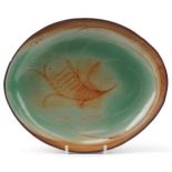 Oval studio pottery dish hand painted with a crustacean, impressed S T initials to the base, 31.