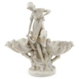 Large Parian style porcelain centrepiece in the form of a semi clad female catching a fish, 43cm