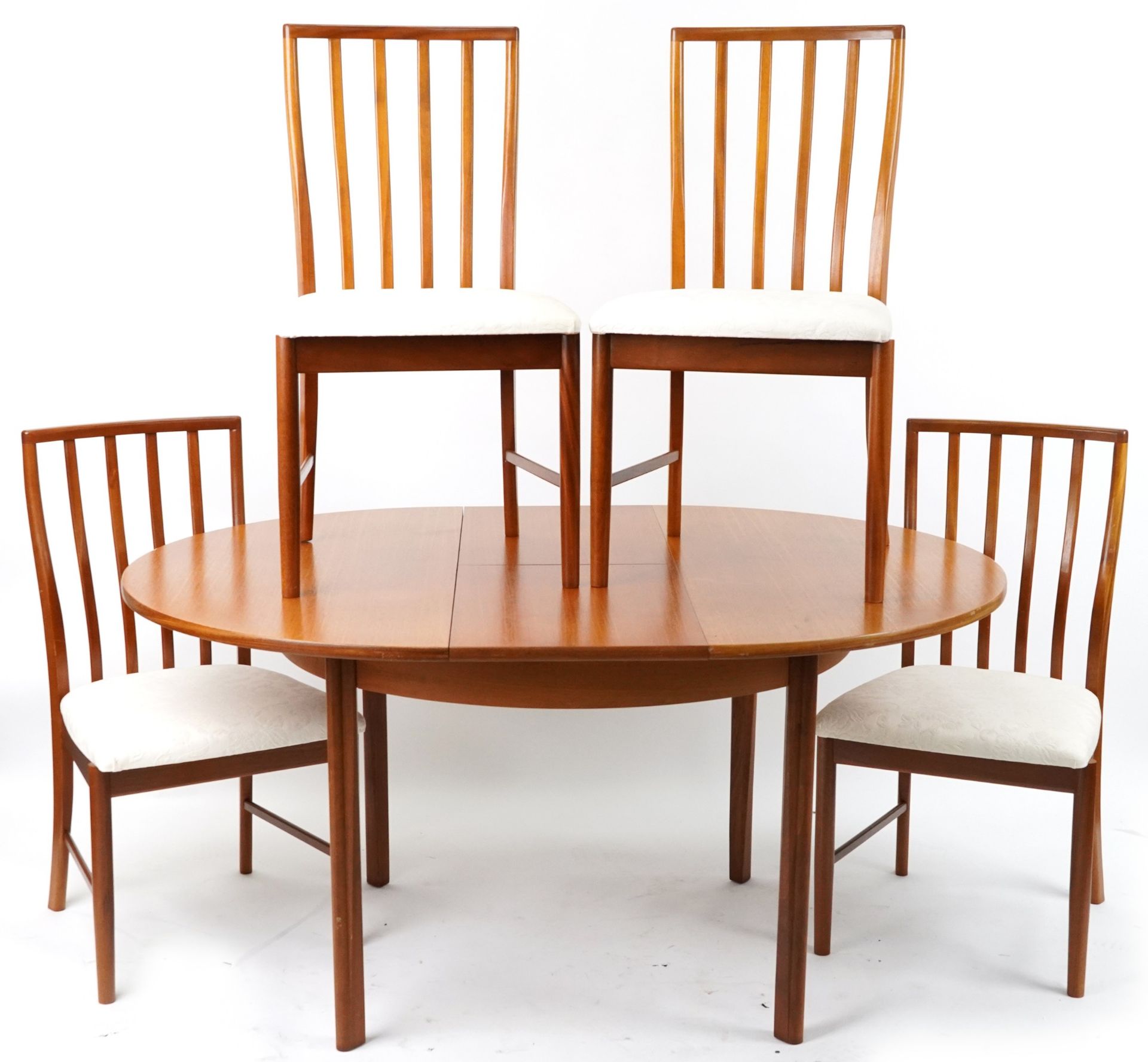 Mackintosh, mid century Scottish teak circular extending dining table with four chairs, the table