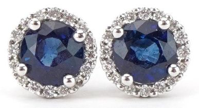 Pair of unmarked gold diamond and sapphire stud earrings, each sapphire approximately 5.50mm in