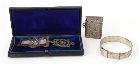 Silver objects comprising floral engraved vesta, floral engraved bracelet and a masonic jewel with