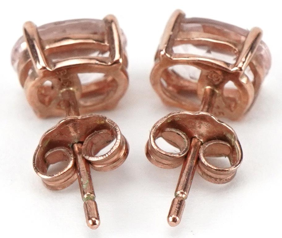 Pair of 9ct rose gold pink stone stud earrings, each 7mm high, total 1.1g - Image 2 of 2