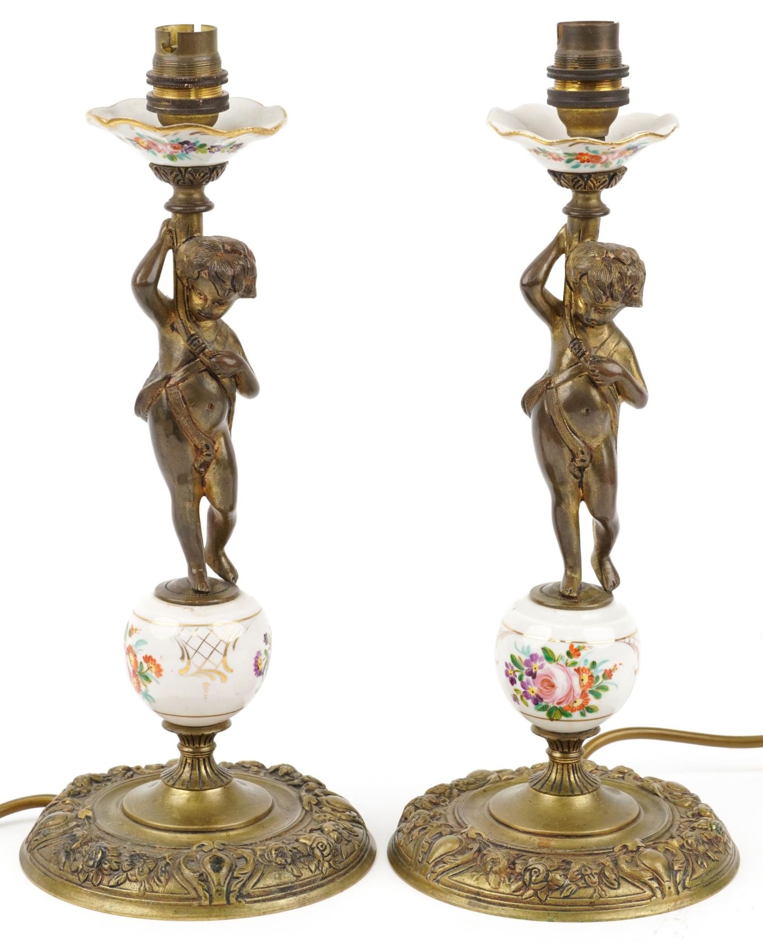 Pair of gilt brass and porcelain Putti design candlesticks hand painted with flowers, each 35cm high