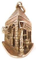 Large 9ct gold charm in the form of a crooked Pub on the Corner, 2.5cm high, 7.0g