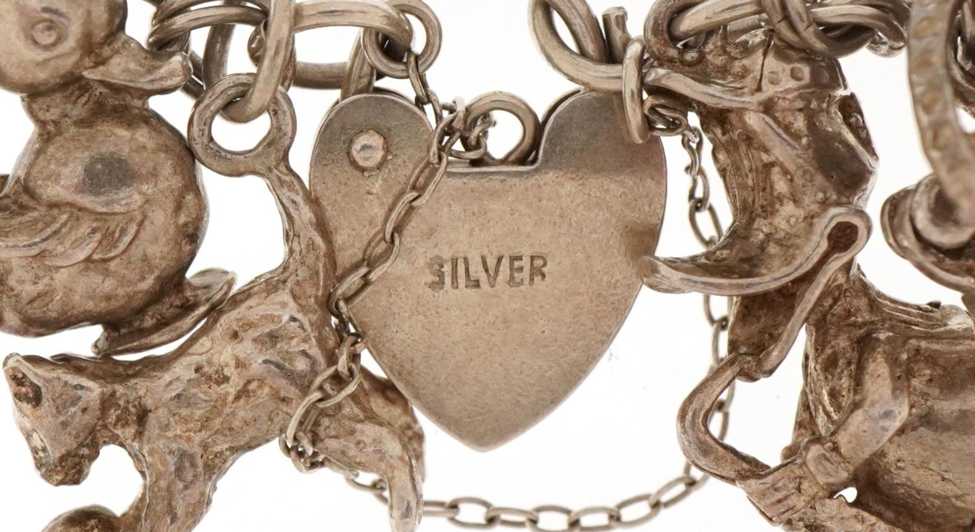 Silver charm bracelet with a large collection of mostly silver charms, 66.6g - Image 3 of 3