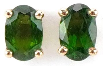 Pair of 9ct gold green stone solitaire stud earrings, possibly olivine, each 6.0mm high, total 0.8g