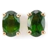 Pair of 9ct gold green stone solitaire stud earrings, possibly olivine, each 6.0mm high, total 0.8g