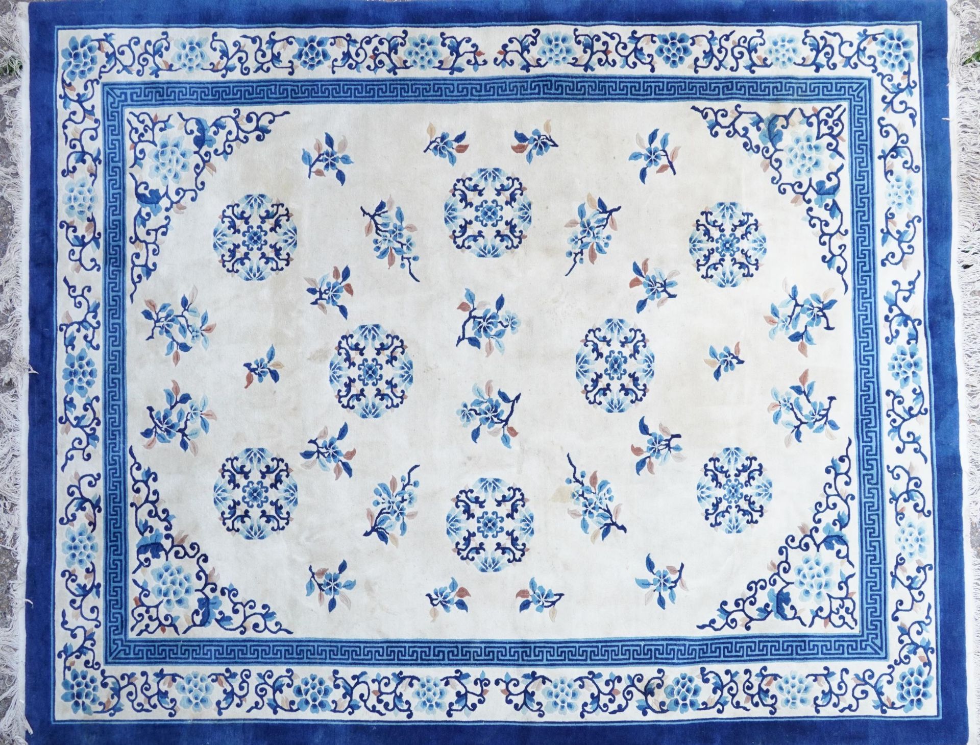 Large Chinese blue and cream ground rug having an allover floral design, 370cm x 275cm