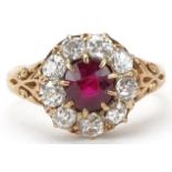 18ct gold ruby and diamond cluster ring, total diamond weight approximately 0.90 carat, the ruby