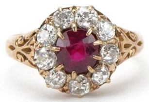18ct gold ruby and diamond cluster ring, total diamond weight approximately 0.90 carat, the ruby