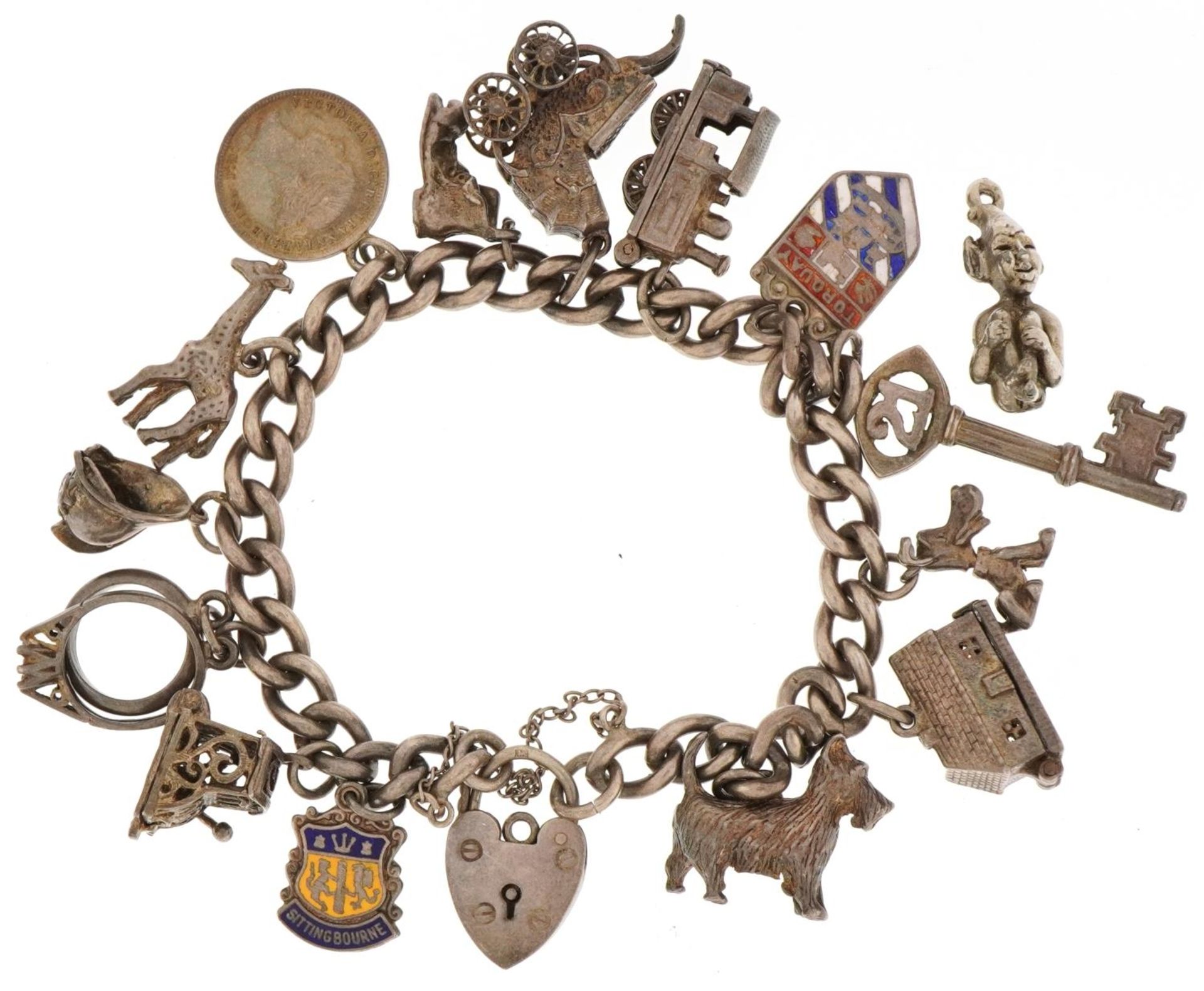 Silver charm bracelet with a collection of mostly silver charms, 57.6g