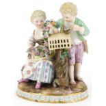 Hand painted Meissen porcelain figure group of a boy, girl with bird cage, blue crossed swords