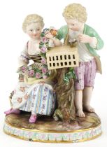 Hand painted Meissen porcelain figure group of a boy, girl with bird cage, blue crossed swords