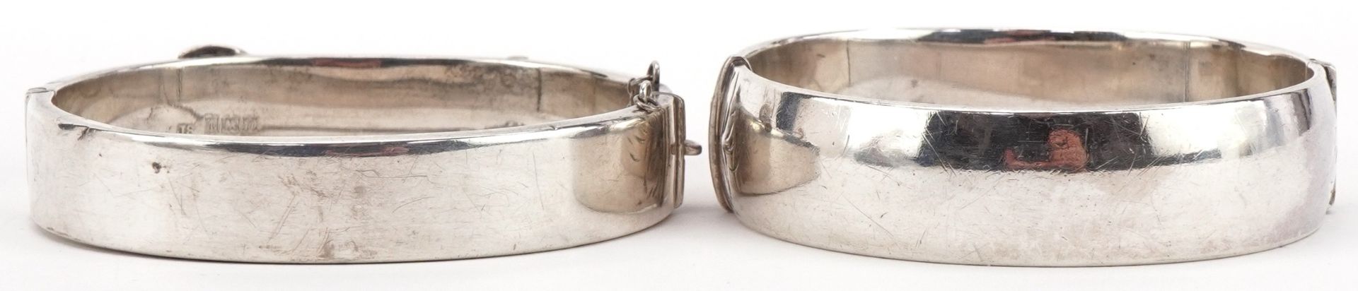 Two Victorian style floral engraved hinged bangles, one in the form of a buckle, each 6.5cm wide, - Image 2 of 4