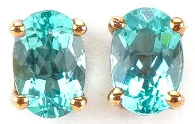 Pair of 9ct gold blue stone solitaire stud earrings, each 6mm high, total 0.9g