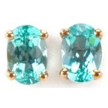 Pair of 9ct gold blue stone solitaire stud earrings, each 6mm high, total 0.9g