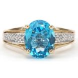 9ct gold blue topaz solitaire ring with diamond set shoulders, size P/Q, 3.3g