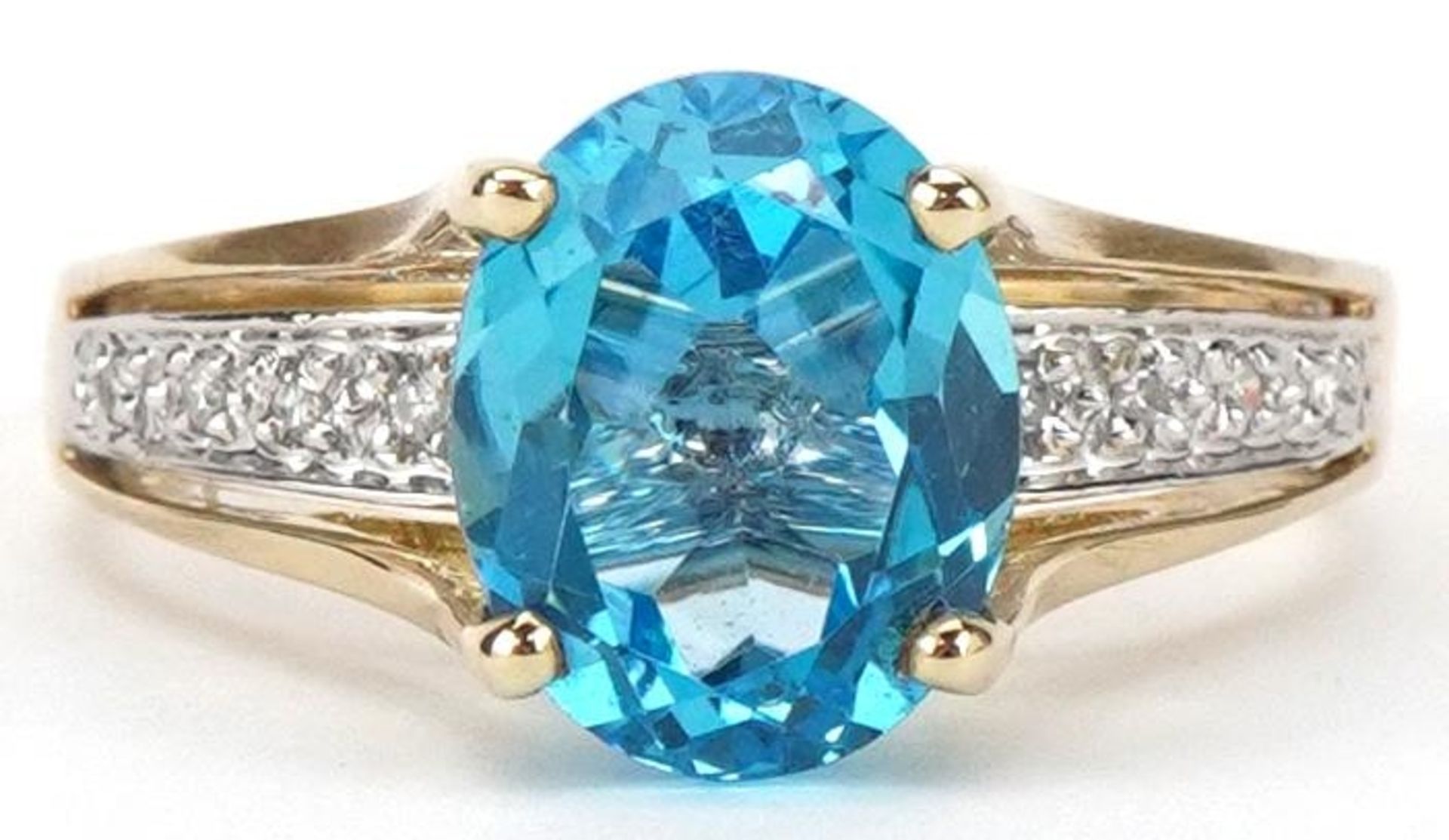 9ct gold blue topaz solitaire ring with diamond set shoulders, size P/Q, 3.3g