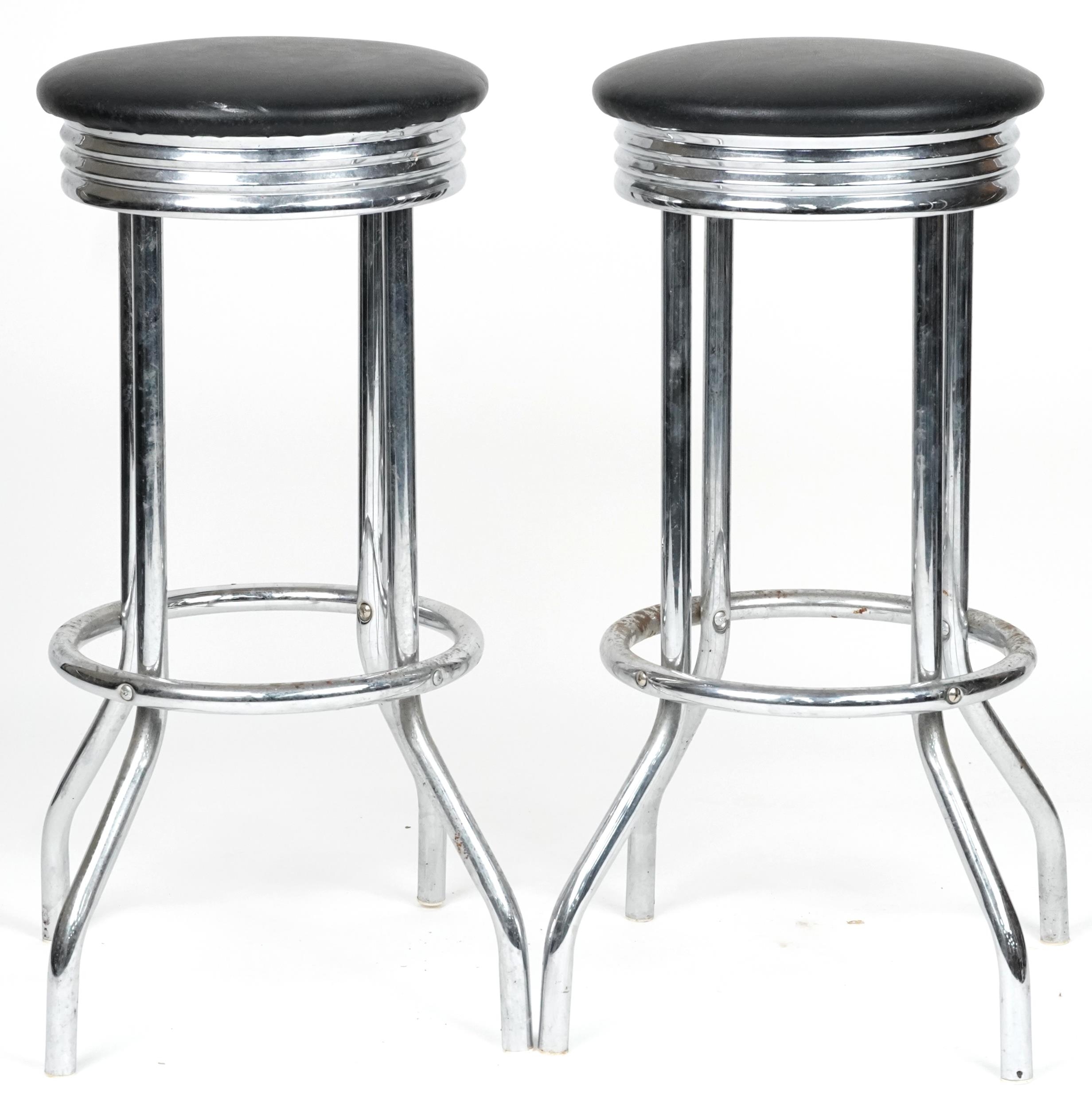 Pair of chrome breakfast bar stools with black faux leather cushioned seats, each 77cm high