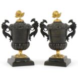 Pair of Victorian Neo-Classical lidded bronze urns with bird design handles and ormolu rose design