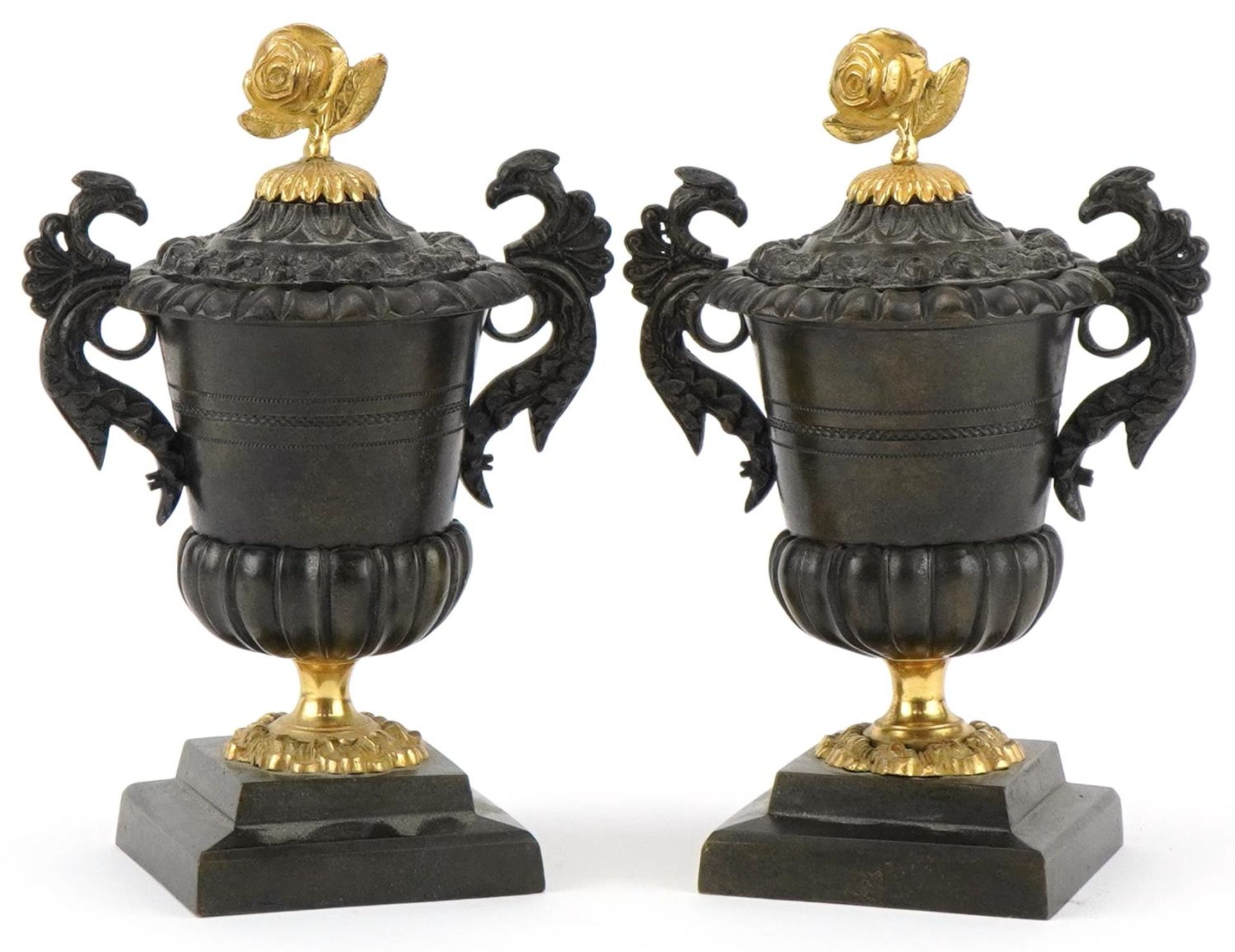 Pair of Victorian Neo-Classical lidded bronze urns with bird design handles and ormolu rose design