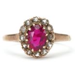 9ct gold ruby and clear stone cluster ring, the ruby approximately 7.10mm x 5.50mm x 3.0mm deep,