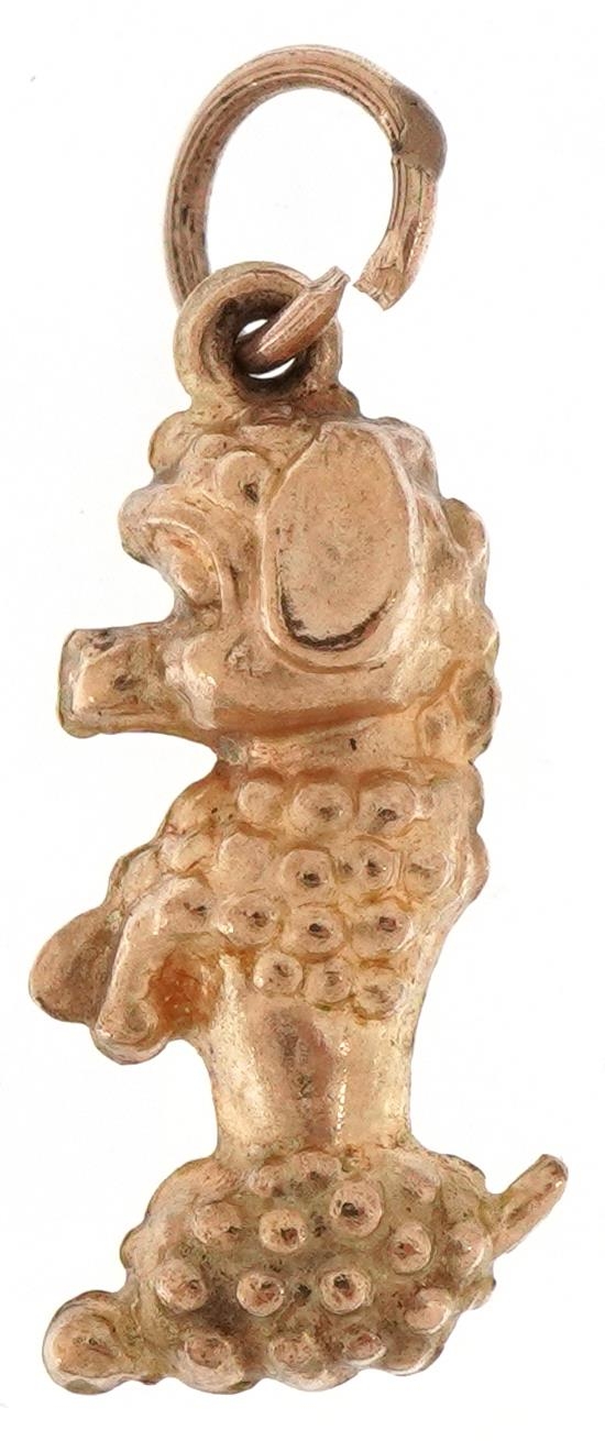 9ct gold charm in the form of a seated Poodle, 2.1cm high, 0.8g