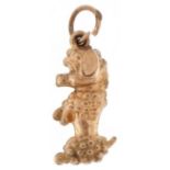 9ct gold charm in the form of a seated Poodle, 2.1cm high, 0.8g