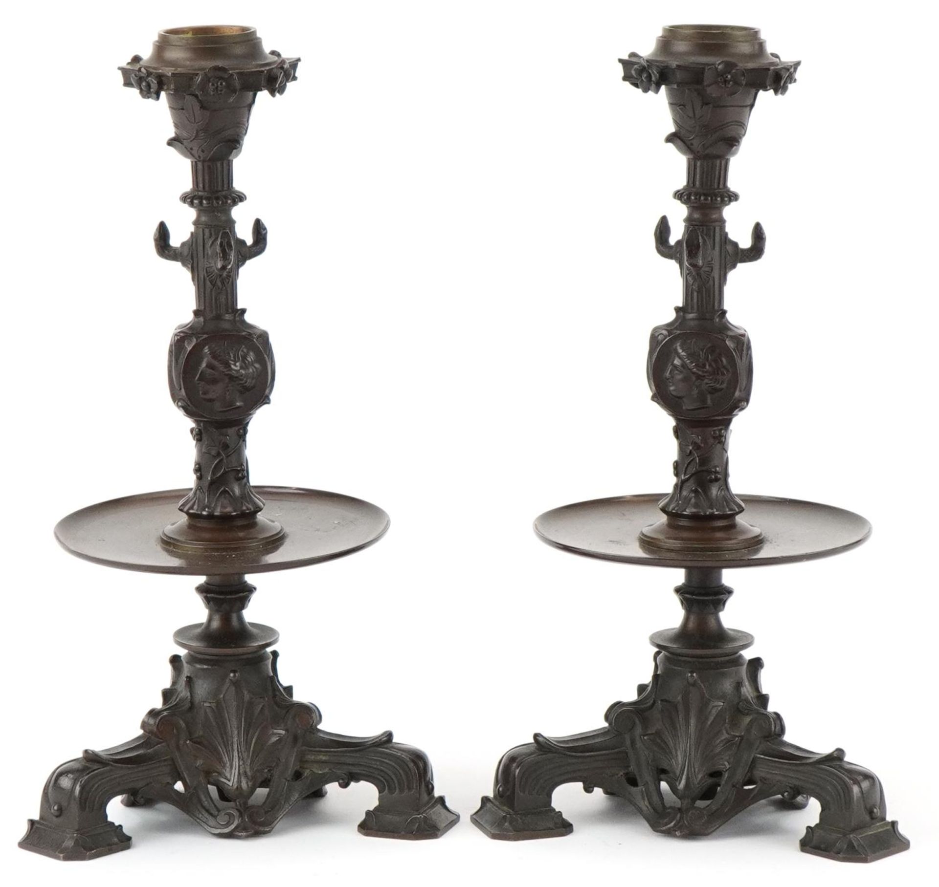 Pair of Victorian Neo-Classical bronze candlesticks decorated with portraits and flowers, 23cm high