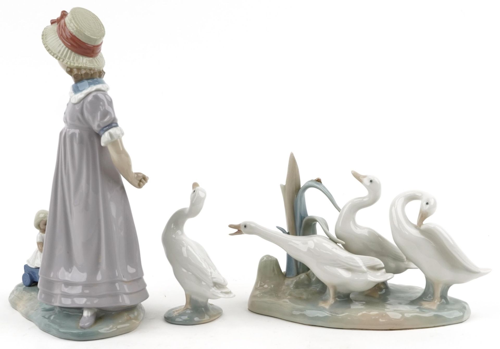 Lladro model of a girl with her doll in a cart together with a model of geese and a single goose, - Image 2 of 4