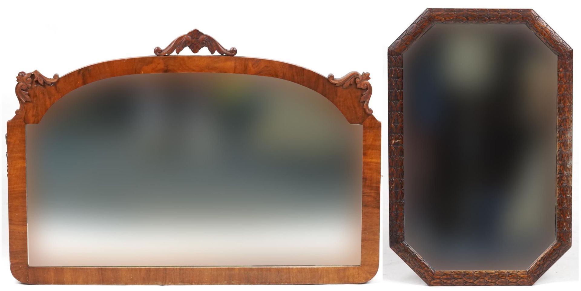 Two Victorian and later wall hanging mirrors including an oak example profusely carved with foliage,