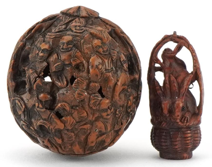 Chinese walnut carved with figures and a Japanese boxwood netsuke carved with three rabbits in a