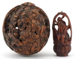 Chinese walnut carved with figures and a Japanese boxwood netsuke carved with three rabbits in a