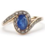 9ct gold blue topaz and diamond crossover ring, size P, 2.7g