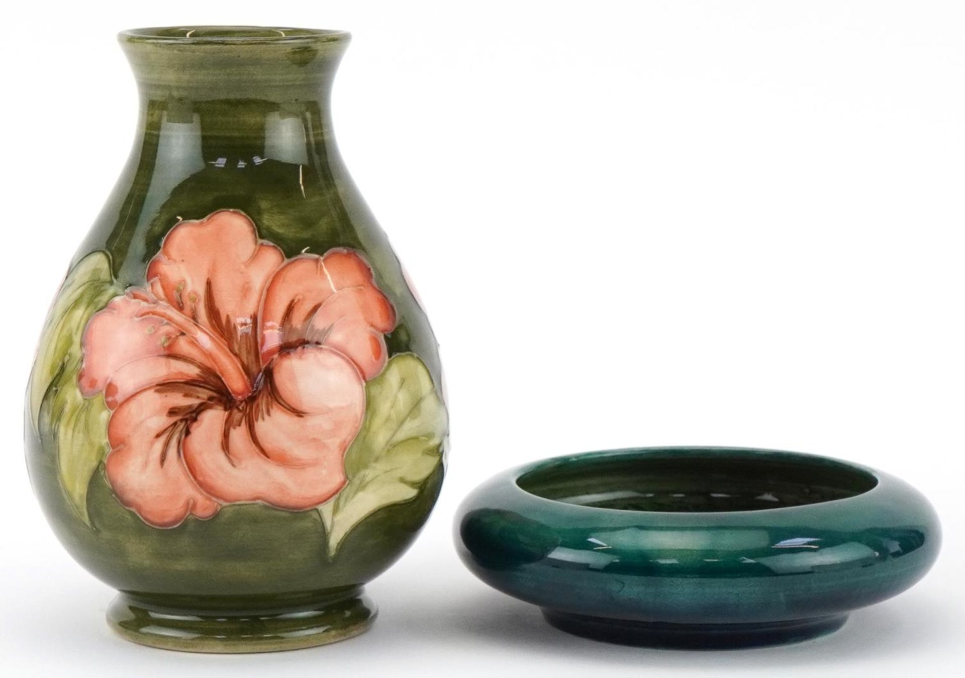 Moorcroft pottery comprising a baluster vase hand painted and tubelined in the Hibiscus pattern