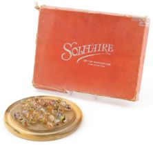 Boxed wooden solitaire board and selection of air twist marbles, the board 20cm in diameter