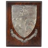 Early 20th century white metal heraldic shield on oak back with Fisher of Birmingham plaque to the