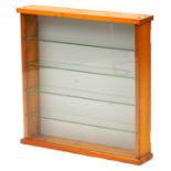 Glazed lightwood wall hanging display case with four glass shelves, 55cm H x 55cm W x 11cm D