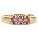 9ct gold ruby three stone ring, size N/O, 2.0g