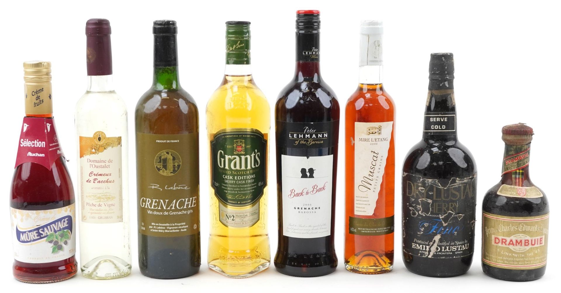 Eight bottles of alcohol including Grant's Cask Edition whisky and Drambuie