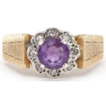 9ct gold amethyst and diamond flower head ring with engine turned shoulders, size O, 3.7g