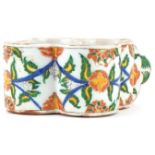 Turkish Ottoman Armenian Kutahya cup hand painted with faces and stylised flowers, 15.5cm in length