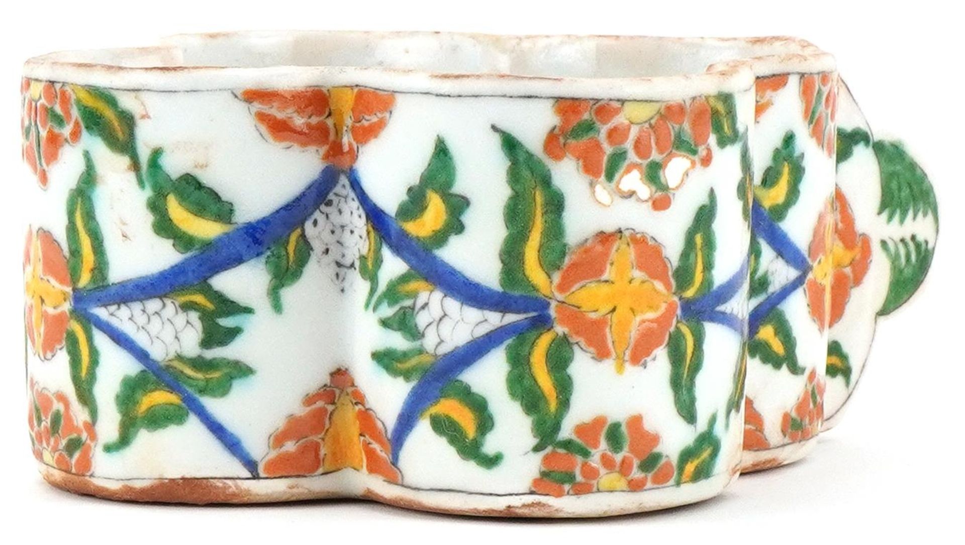 Turkish Ottoman Armenian Kutahya cup hand painted with faces and stylised flowers, 15.5cm in length