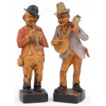 Pair of hand painted European carved wooden statues of musicians, each 15cm high