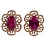 Pair of 9ct gold ruby stud earrings, each 1cm high, total 1.4g